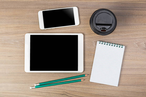 istock White digital tablet on wooden table. Flat lay. 1225737372