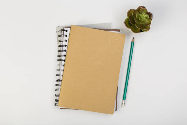 istock a stack of several spiral school notebooks lies on a white table with a pencil, office concept 1225737575