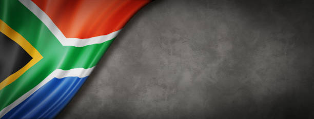 South African flag on concrete wall banner South Africa flag on concrete wall. Horizontal panoramic banner. south africa flag stock pictures, royalty-free photos & images