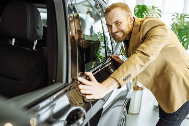 istock young caucasian guy examining new car before making purchase 1225739995