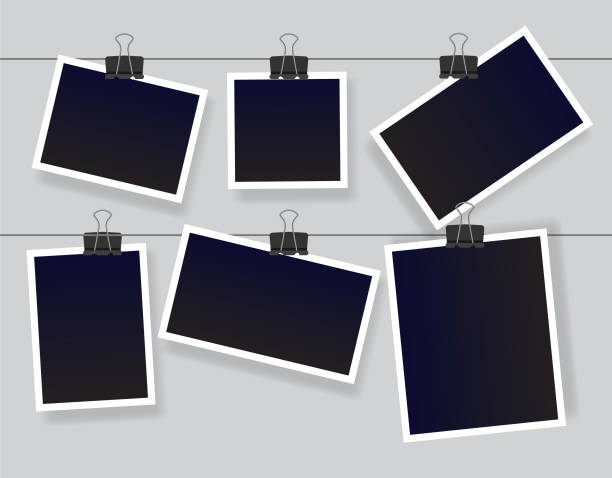 Black empty vintage photo frames templates. Blank instant photo frame set hanging on a clip. Black empty vintage photo frames templates. Vector illustration isolated on grey background. clothesline photos stock illustrations