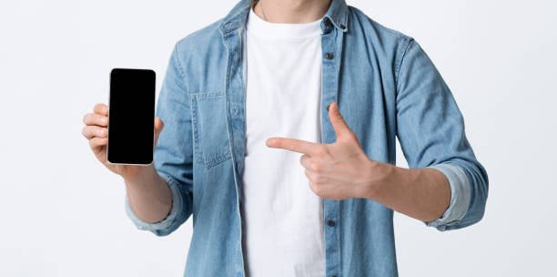 istock Male finger points to smartphone blank screen 1225743246