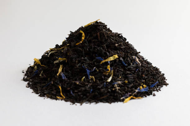 istock dried black tea leaves on a white background. 1225743358