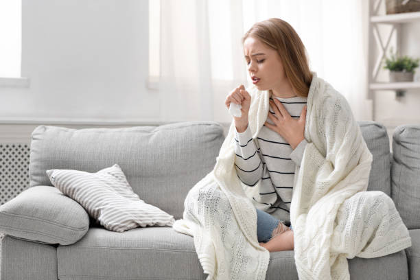 istock Young woman coughing hardly at home, free space 1225743663