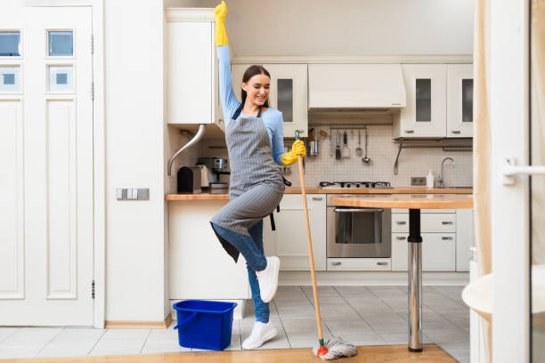 istock Young woman cleaning kitchen floor dancing with mop 1225743873