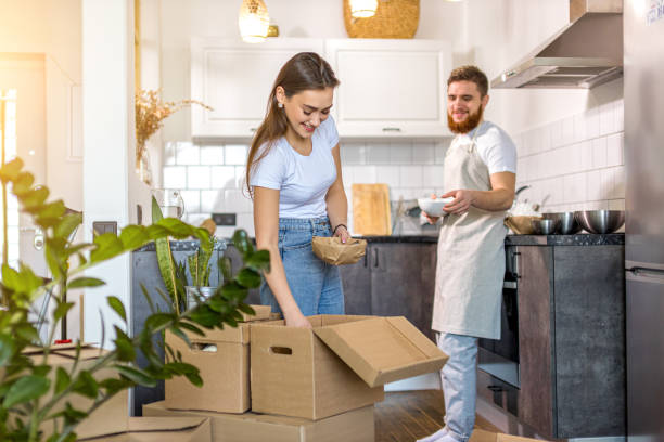 istock young caucasian married couple unpacking boxes at home 1225744483