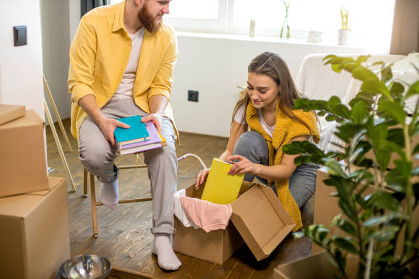 istock young caucasian couple unpack cardboard box at home 1225744957