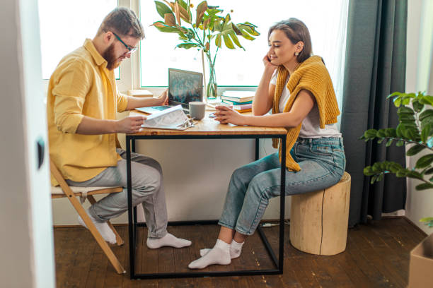 istock cute wife look at working husband with love 1225746203