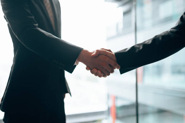 istock businessman meet-up handshake 1225746593