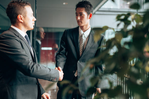istock businessman meet-up handshake 1225746644
