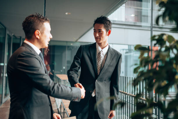 istock businessman meet-up handshake 1225747587