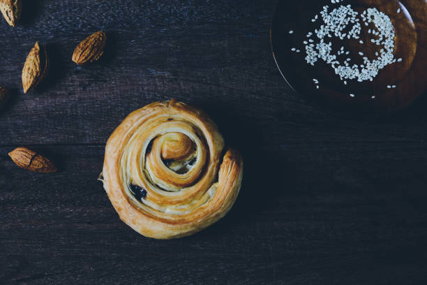 istock Bread Denis with Chocolate chips with almond on wood background. 1225747824