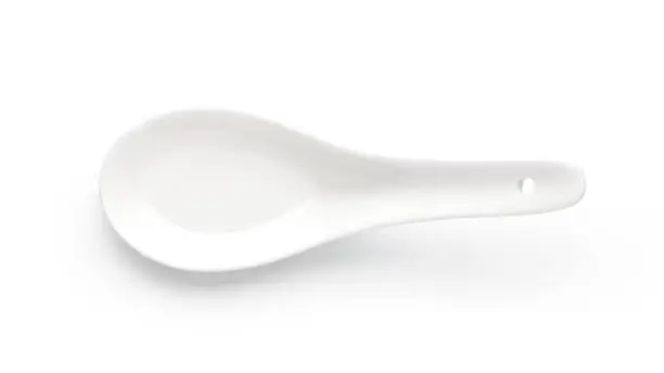 Empty ceramic spoon isolated on white background. Top view.