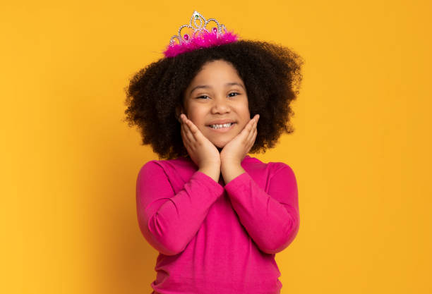 istock Cute Black Girl Posing To Camera With Crown On Head 1225748240