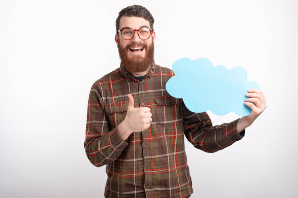 istock Young male student is showing thumb up or like gesture while holding a light blue cloud. 1225748296