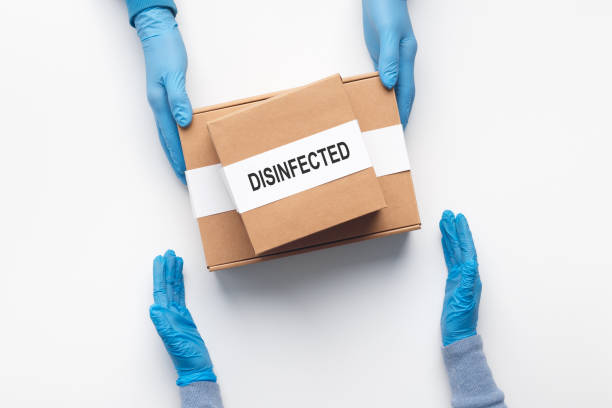 istock Hands in gloves on quarantine get delivery box 1225748517