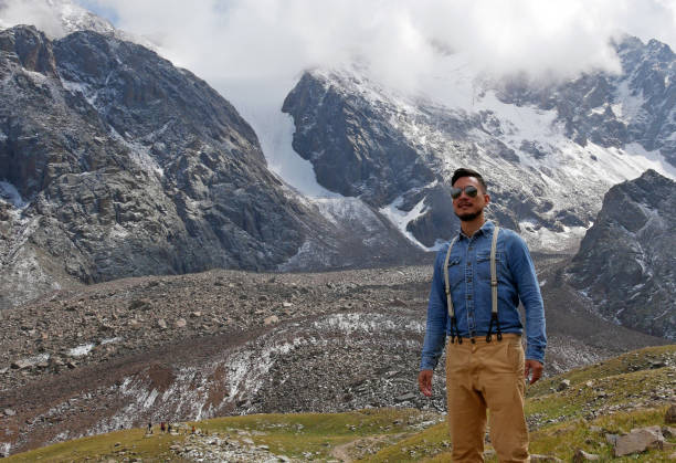 istock Man with aviator sunglasses in front of a mountain panorama 1225749025
