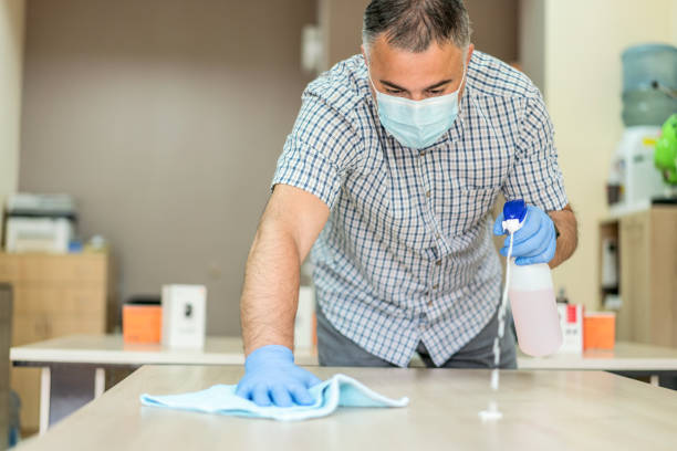 istock Covid-19 wiping down surfaces in the office 1225750940
