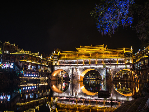 Scenery view of hong bridge and building in the night of fenghuang old town .phoenix ancient town or Fenghuang County is a county of Hunan Province, China