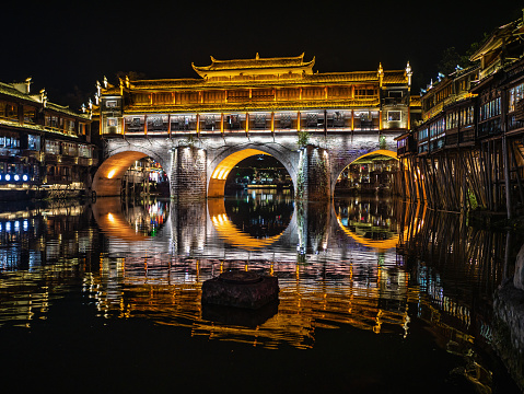 Scenery view of hong bridge and building in the night of fenghuang old town .phoenix ancient town or Fenghuang County is a county of Hunan Province, China