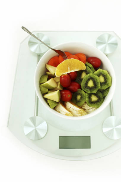 istock A Bowl Of Fruit And Vegetable Salad On Weight Scale 1225757159