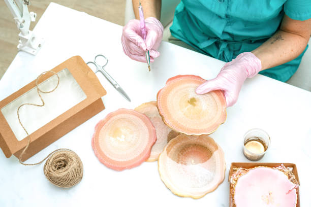 istock Creativity and craft. A young girl creates coasters from resin. Gift wrapping. Decorative packaging. Idea for business. Remote work, work at home. Art coasters. 1225758003