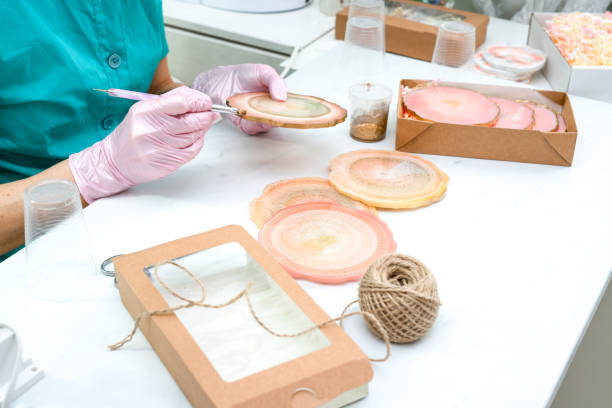 istock Creativity and craft. A young girl creates coasters from resin. Gift wrapping. Decorative packaging. Idea for business. Remote work, work at home. Art coasters. 1225758006