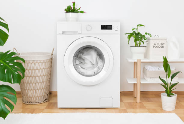 istock Simple interior of home laundry room with modern washing machine 1225758268