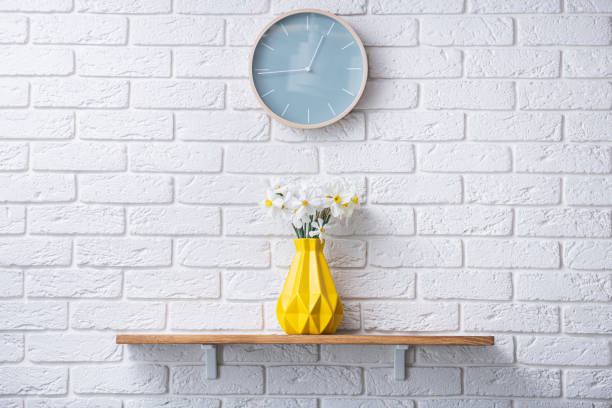 istock Beautiful daffodil flowers in yellow vase 1225758340