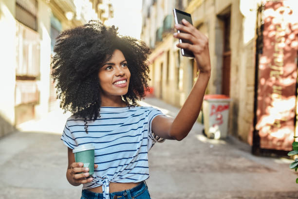 istock Afro girl walking and vlogging 1225759301