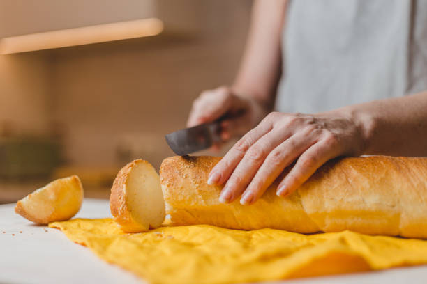 istock Fresh baked baguette bread on wooden cutting board 1225759554
