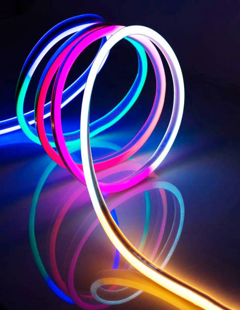 istock Flexible led tape neon flex in different colors on dark black background 1225760252
