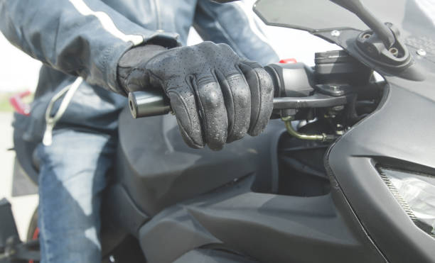 istock Caucasian motorcyclist with a black glove. Transport 1225761054