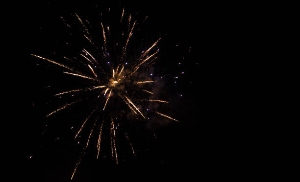 Holiday background with firework Holiday background with firework. Beautiful Single Golden firework isolated on black background. Template With Copy Space for design Greeting card for holidays and celebrations gold layer stock pictures, royalty-free photos & images