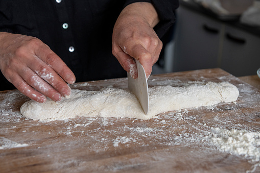 Baker portioned dough in bread size.