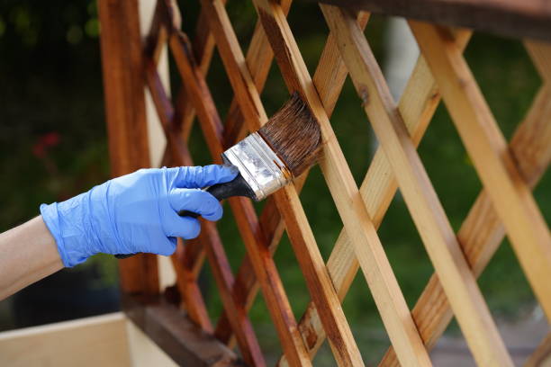 istock worker paints wooden furniture with protective paint 1225762847