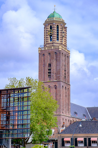 Utrecht, the Netherlands - May 27, 2013: The city centre of Utrecht with the Dom Tower. The church in front of the Dom Tower is called Buurkerk. Left from the church is the city street Steenweg. People are shopping.
