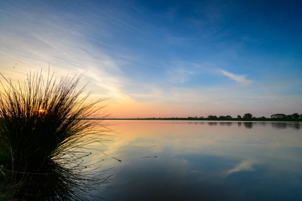 Springtime sunset over an empty lake during a beautiful evening in May at the Reevediep near Kampen in Overijssel, The Netherlands.