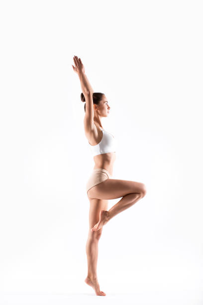 istock Young flexible woman doing gymnastics exercises isolated on white background. 1225764759