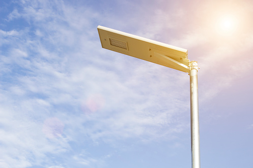 Electric poles illuminated with solar cells and clear blue sky for sidewalks or parks. Devices that help save electricity and conserve the environment, including saving costs