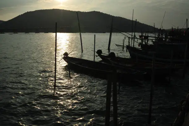 Photo of Small fishing boats dock at the shore