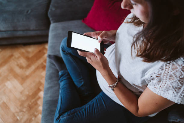 istock young pregnant woman at home using mobile phone 1225766144