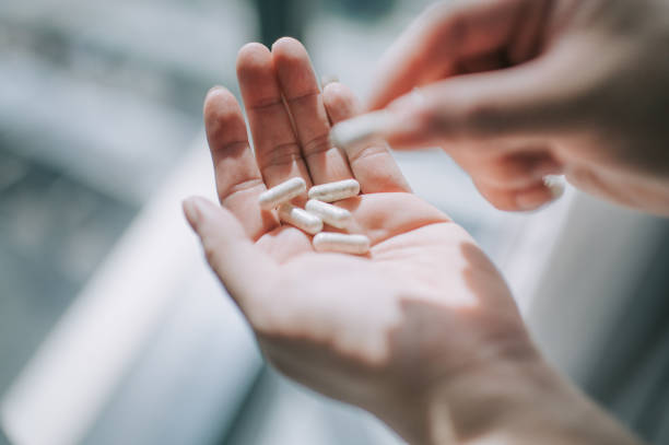 istock close up on human hand taking medicine pill supplement vitamin 1225766365