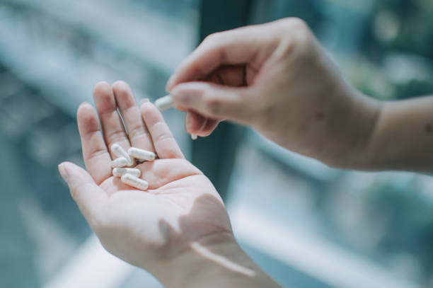 istock close up on human hand taking medicine pill supplement vitamin 1225766369