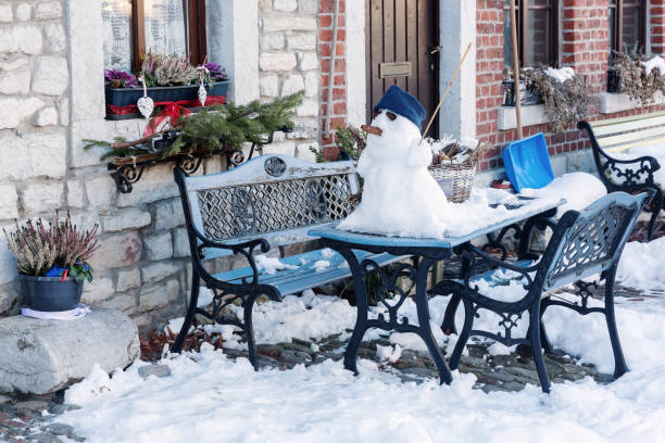 picture of a winter scene with a snowman on a garden table