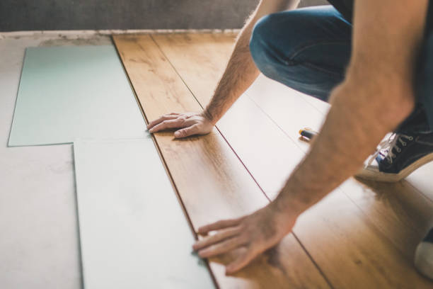 istock The builder is engaged in laying laminate in the room 1225769129
