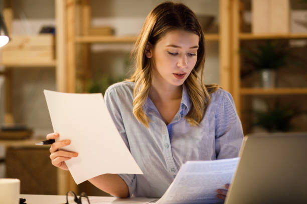 istock Young woman doing finances at home using laptop 1225769591