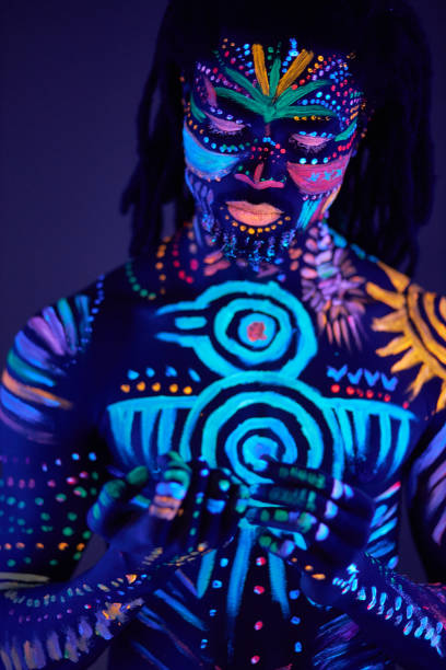 istock portrait of african man with ethnic pattern, neon makeup in ultraviolet light 1225771086