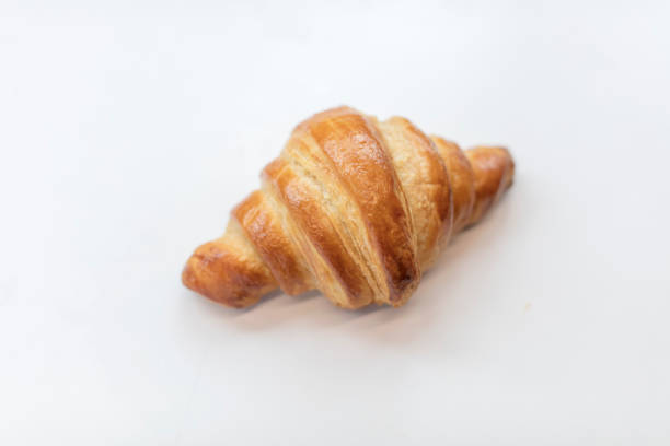 istock Freshly Baked Croissant on a Light Background 1225772342