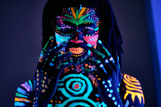 istock man in UV paint isolated, dark background 1225774557